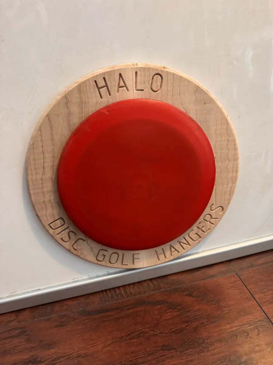 Dyed maple hanger holding a disc
